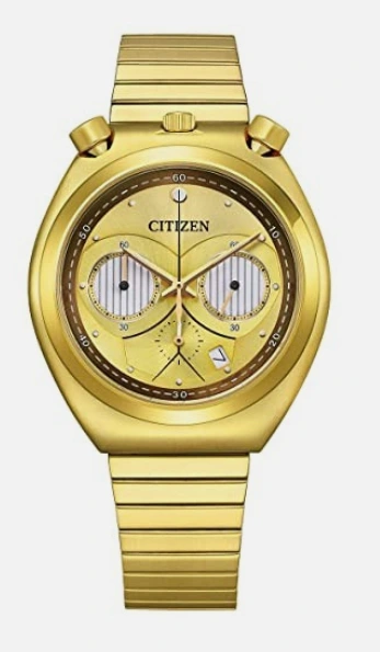 A gold watch, inspired by C3PO's design. There are two round complications on the watch face which look like C3PO's eyes. The time is 10 past 10 which causes the hands to overlap the eyes in such a way that the watch looks like a very angry face.